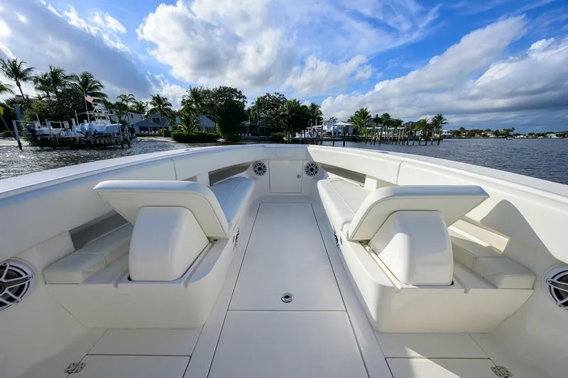Reel Craft Yacht Photos Pics 2024 SeaVee 340Z boat interior with white seating, dockside view, and blue sky.