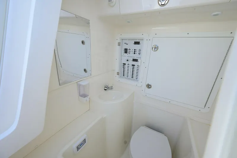Reel Craft Yacht Photos Pics 2024 SeaVee 340Z boat interior with control panel, sink, and toilet.