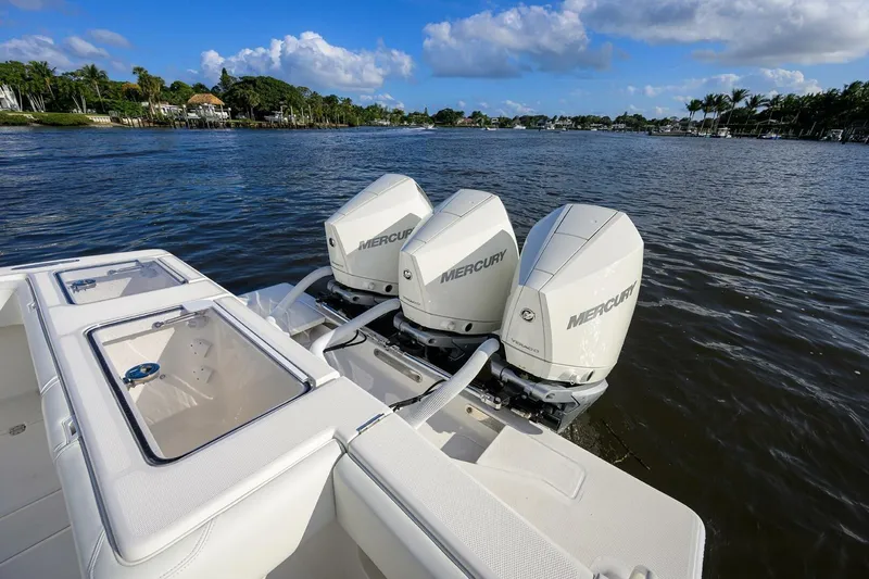 Reel Craft Yacht Photos Pics 2024 SeaVee 340Z boat with triple Mercury engines on a calm waterway.