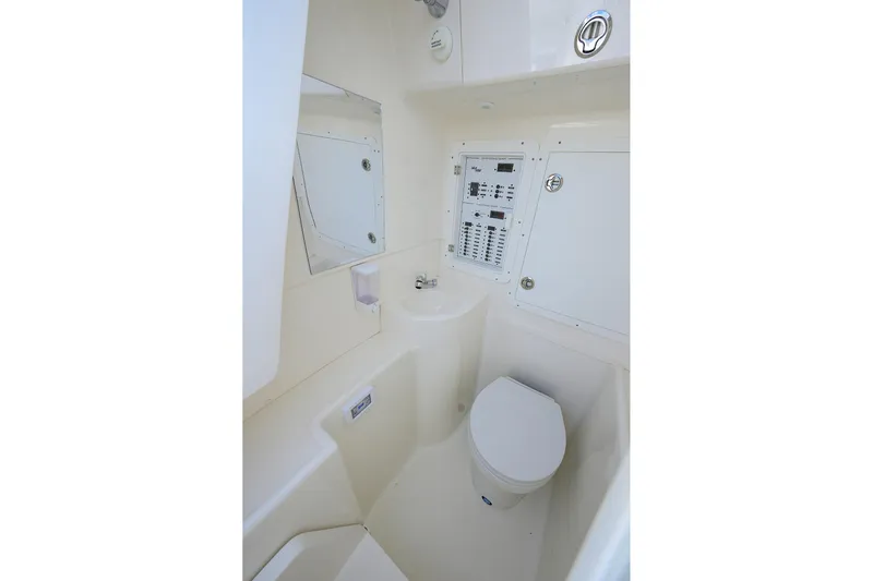 Reel Craft Yacht Photos Pics 2024 SeaVee 340Z boat interior with toilet and control panel.
