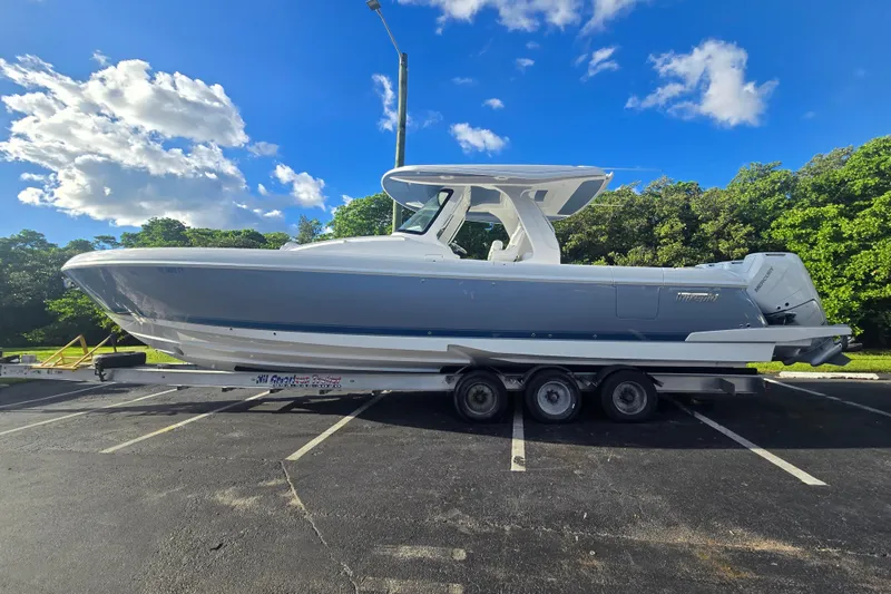  Yacht Photos Pics 2025 Intrepid 41 Panacea boat on trailer under blue sky and clouds.
