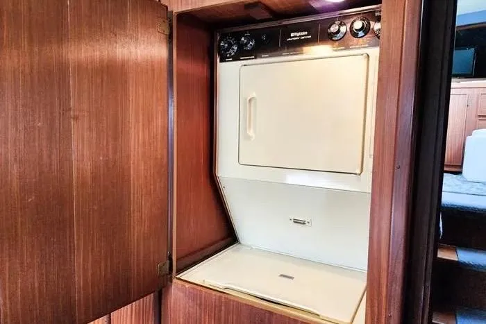  Yacht Photos Pics Laundry area inside 1988 Hatteras 43 Motor Yacht with built-in washer and dryer.
