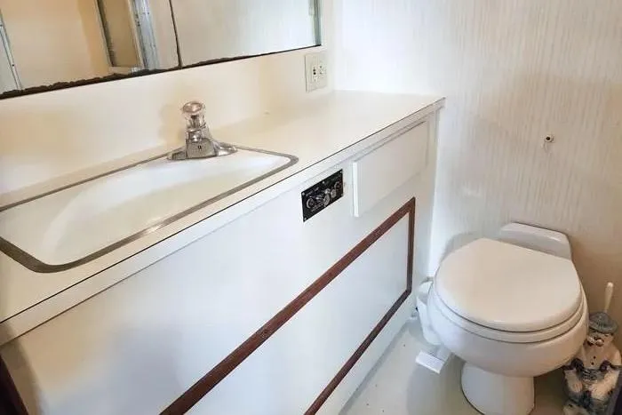  Yacht Photos Pics Bathroom interior of 1988 Hatteras 43 Motor Yacht with sink and toilet.