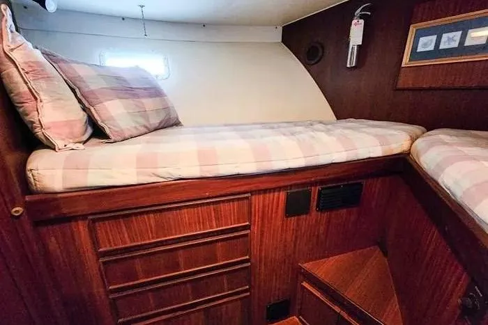  Yacht Photos Pics 1988 Hatteras 43 Motor Yacht cabin with twin beds and wooden interior.
