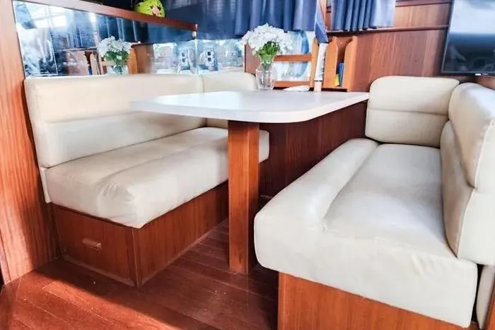  Yacht Photos Pics Interior of 1988 Hatteras 43 Motor Yacht with cozy dining area and plush seating.