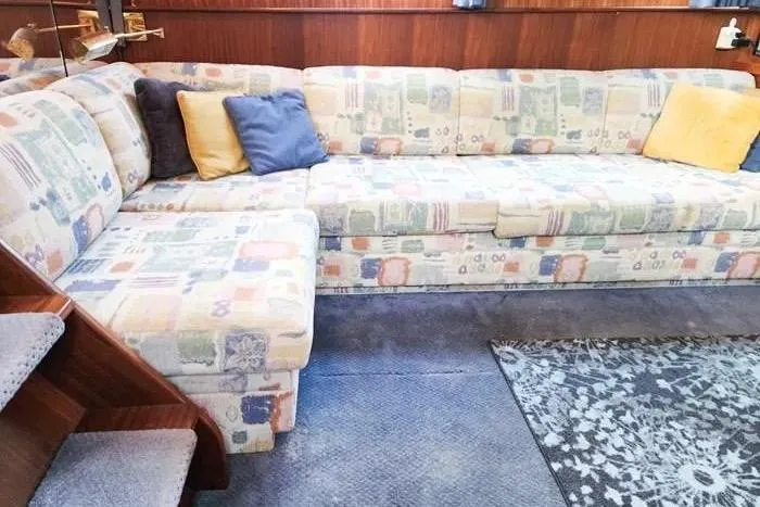  Yacht Photos Pics 1988 Hatteras 43 Motor Yacht interior with patterned sofa and colorful cushions.