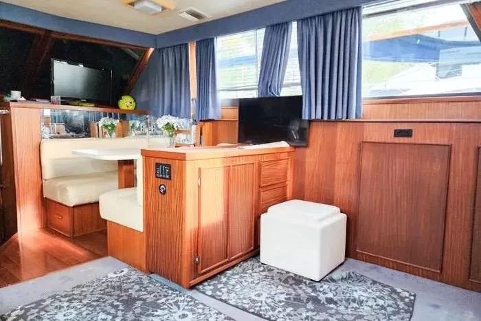  Yacht Photos Pics Interior of 1988 Hatteras 43 Motor Yacht with wood paneling and cozy seating area.