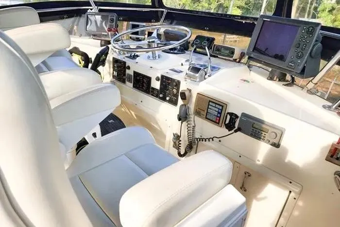  Yacht Photos Pics 1988 Hatteras 43 Motor Yacht helm with white seating and navigation equipment.