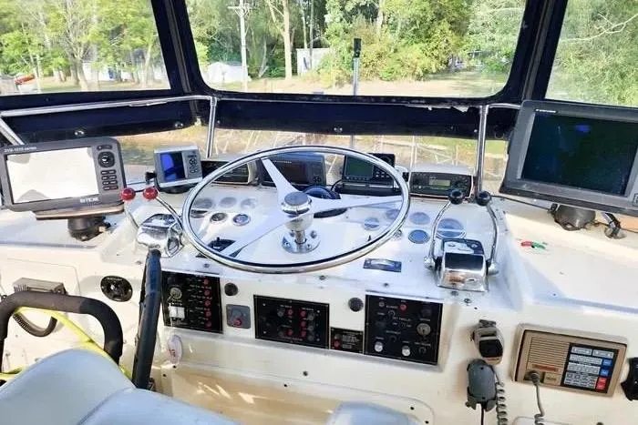  Yacht Photos Pics 1988 Hatteras 43 Motor Yacht helm with navigation equipment and steering wheel.