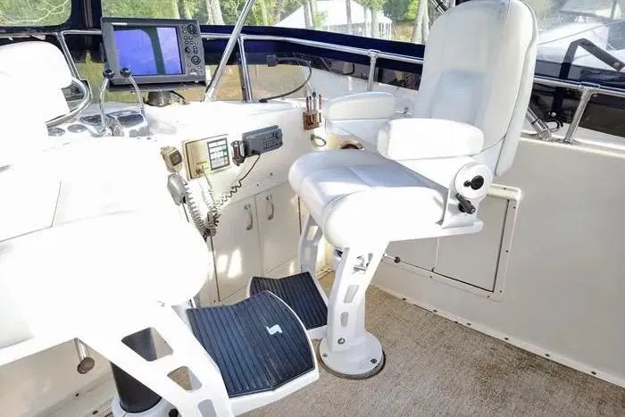  Yacht Photos Pics 1988 Hatteras 43 Motor Yacht helm with white captain's chairs and navigation equipment.