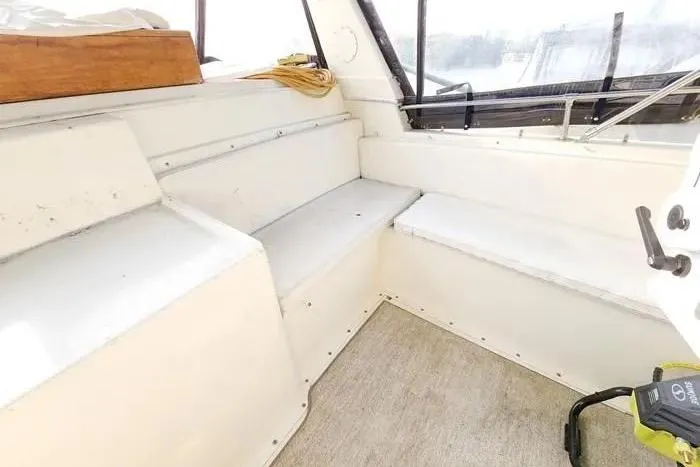  Yacht Photos Pics 1988 Hatteras 43 Motor Yacht interior seating area with beige upholstery and windows.