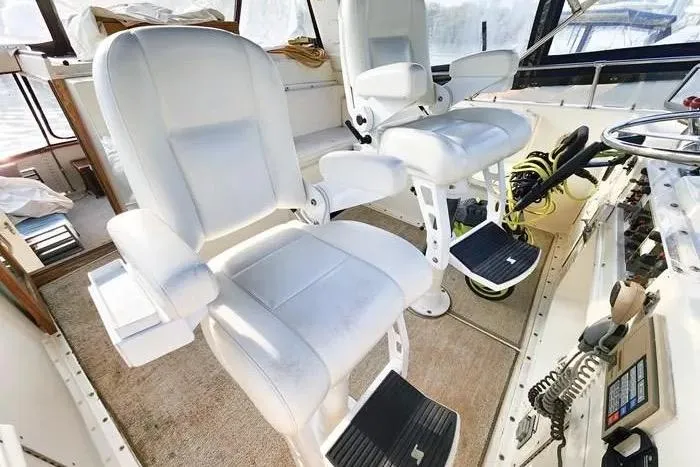  Yacht Photos Pics Captain's chairs on 1988 Hatteras 43 Motor Yacht bridge, featuring helm controls and navigation equipment.