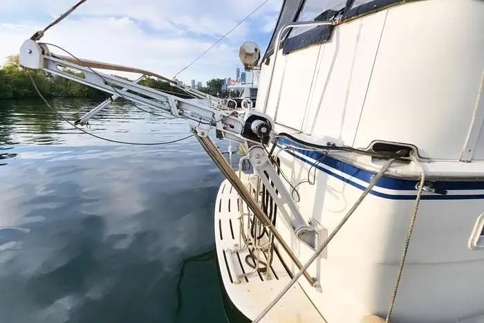  Yacht Photos Pics 1988 Hatteras 43 Motor Yacht stern view with davit system on calm water.
