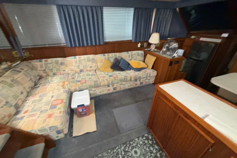  Yacht Photos Pics Interior of 1988 Hatteras 43 Motor Yacht with patterned sofa and wooden cabinetry.