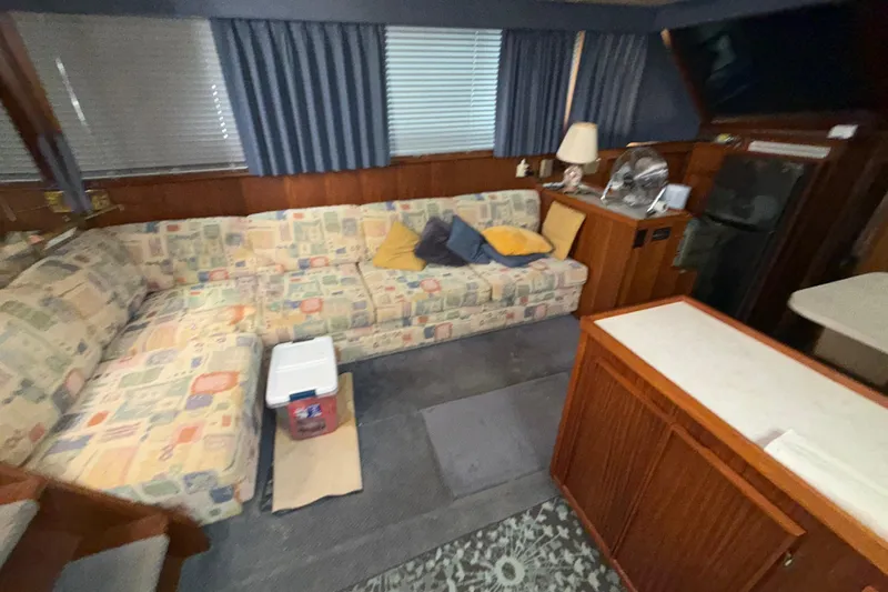  Yacht Photos Pics Interior of 1988 Hatteras 43 Motor Yacht with patterned sofa and wooden cabinetry.