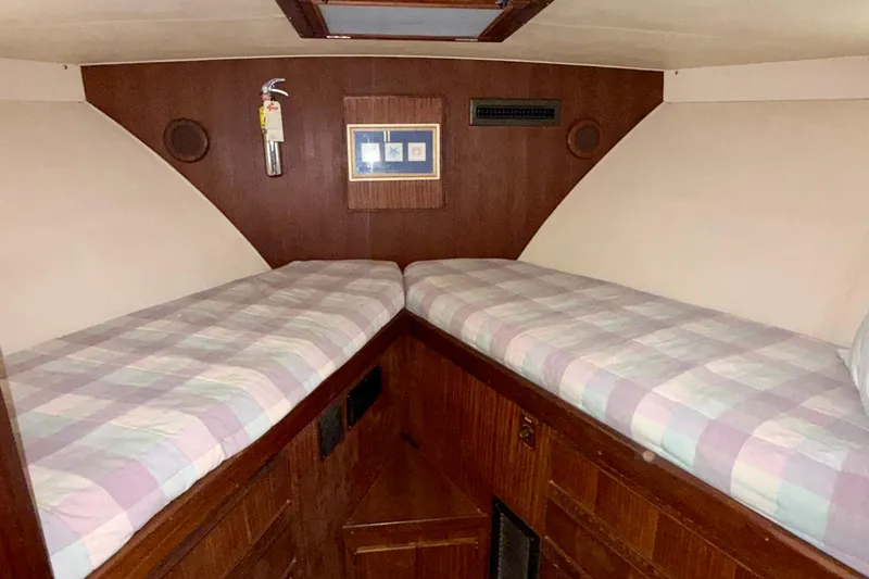  Yacht Photos Pics 1988 Hatteras 43 Motor Yacht cabin with twin beds and wood paneling.