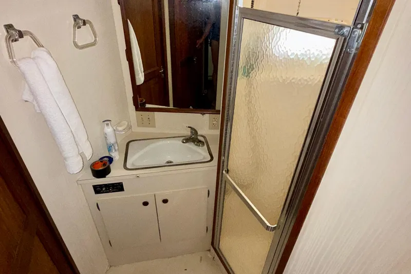  Yacht Photos Pics Bathroom interior of 1988 Hatteras 43 Motor Yacht with sink and shower.