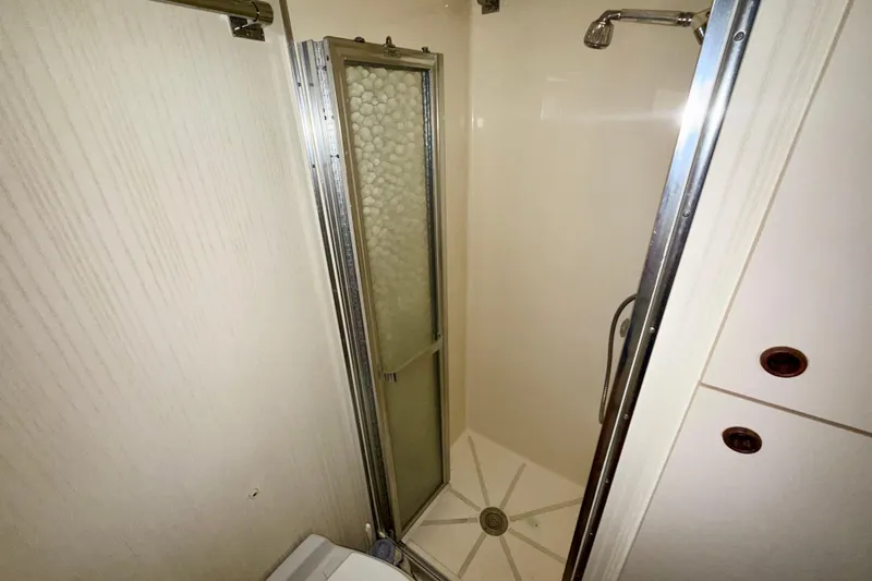  Yacht Photos Pics Shower area in 1988 Hatteras 43 Motor Yacht, featuring sliding door and modern fixtures.