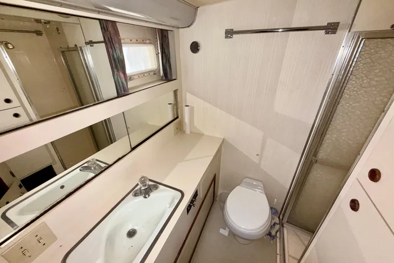  Yacht Photos Pics Bathroom interior of 1988 Hatteras 43 Motor Yacht with sink, toilet, and shower.