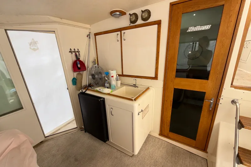  Yacht Photos Pics Interior of 1988 Hatteras 43 Motor Yacht with kitchenette and wooden door.