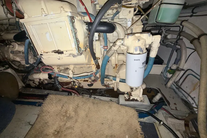  Yacht Photos Pics Engine room of a 1988 Hatteras 43 Motor Yacht, showcasing mechanical components and hoses.