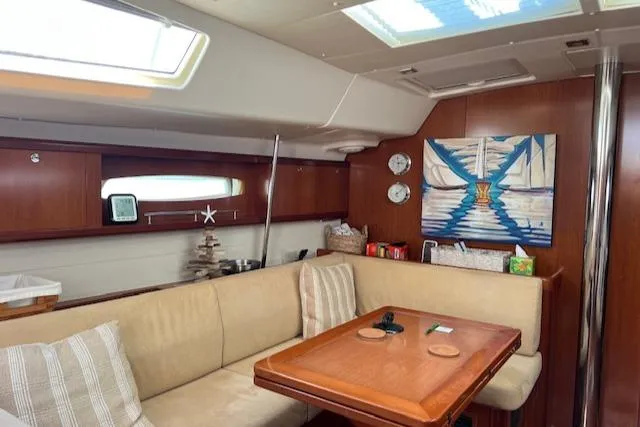 Comfort Zone Yacht Photos Pics Interior of 2007 Beneteau 49 yacht with cozy seating and nautical decor.