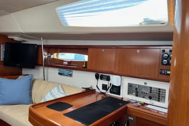 Comfort Zone Yacht Photos Pics Interior of 2007 Beneteau 49 yacht with navigation station and cozy seating area.