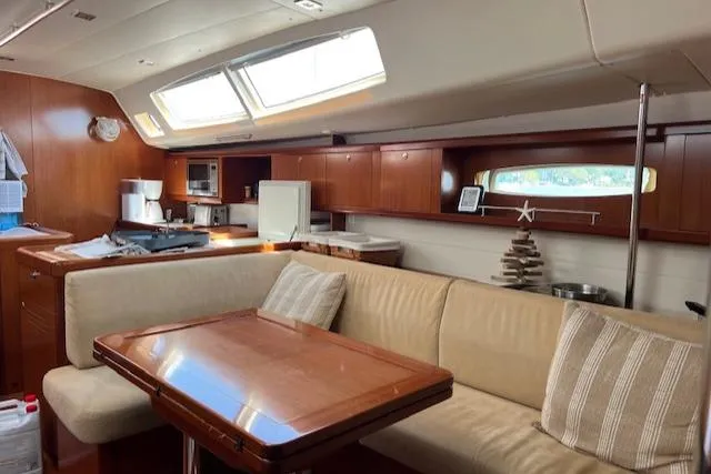 Comfort Zone Yacht Photos Pics Luxurious interior of a 2007 Beneteau 49 yacht with elegant wood finishes and comfortable seating.