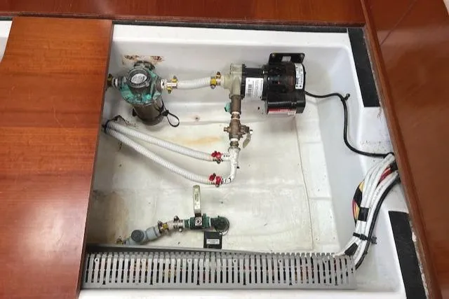 Comfort Zone Yacht Photos Pics Bilge compartment of 2007 Beneteau 49 yacht with pump and plumbing components.