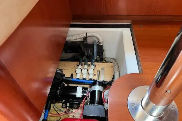 Comfort Zone Yacht Photos Pics Engine compartment of a 2007 Beneteau 49 sailboat, showcasing mechanical components and wiring.