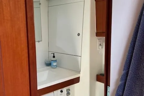 Comfort Zone Yacht Photos Pics Bathroom interior of a 2007 Beneteau 49 yacht, featuring a sink and mirror.