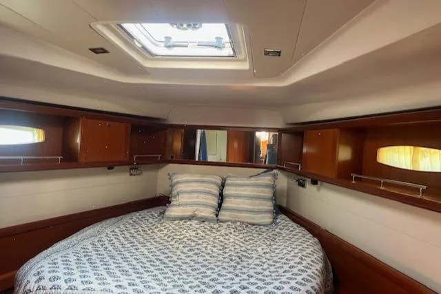 Comfort Zone Yacht Photos Pics Cozy cabin interior of 2007 Beneteau 49 yacht with skylight and wooden accents.