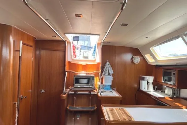 Comfort Zone Yacht Photos Pics Interior of a 2007 Beneteau 49 yacht with wood finish and modern amenities.