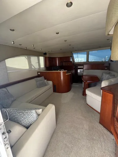  Yacht Photos Pics Luxurious interior of 2009 Silverton 45 Convertible yacht with elegant seating and wood finishes.