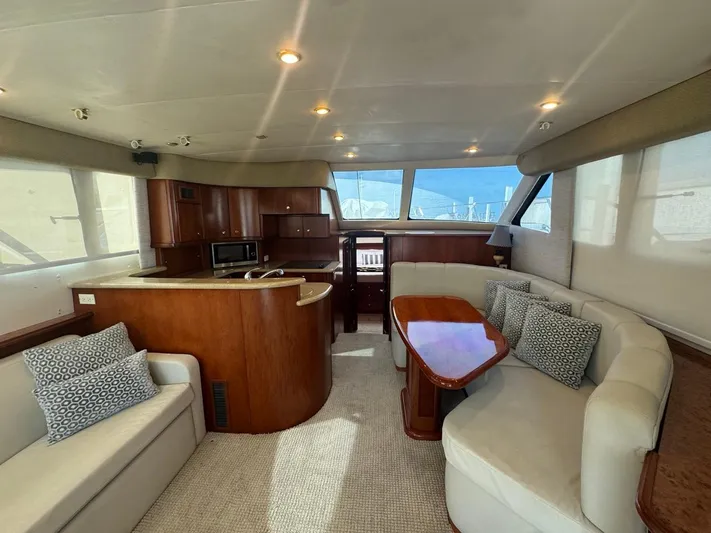 Yacht Photos Pics Luxurious interior of 2009 Silverton 45 Convertible yacht with elegant seating and kitchen area.