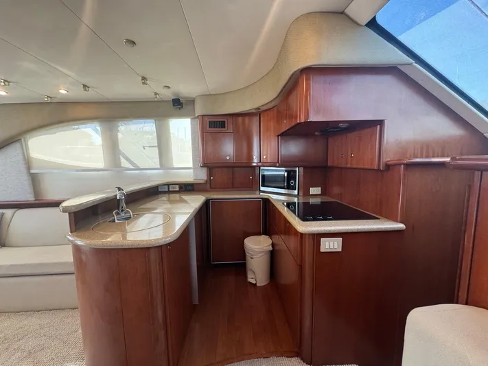 Yacht Photos Pics Luxurious kitchen interior of 2009 Silverton 45 Convertible yacht with wood cabinetry.