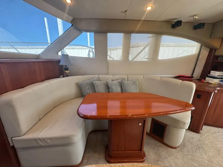  Yacht Photos Pics Interior of 2009 Silverton 45 Convertible yacht with elegant seating and wooden table.
