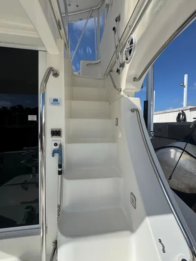  Yacht Photos Pics Staircase on 2009 Silverton 45 Convertible yacht, featuring sleek white design and stainless steel railings.