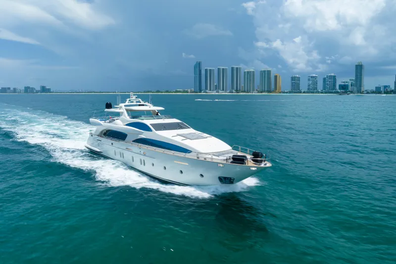  Yacht Photos Pics Luxurious 2012 Azimut yacht cruising near a city skyline under a cloudy sky.