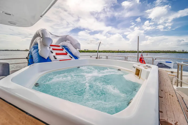  Yacht Photos Pics Luxurious Azimut yacht with jacuzzi and inflatable slide, 2012 model, on serene water.