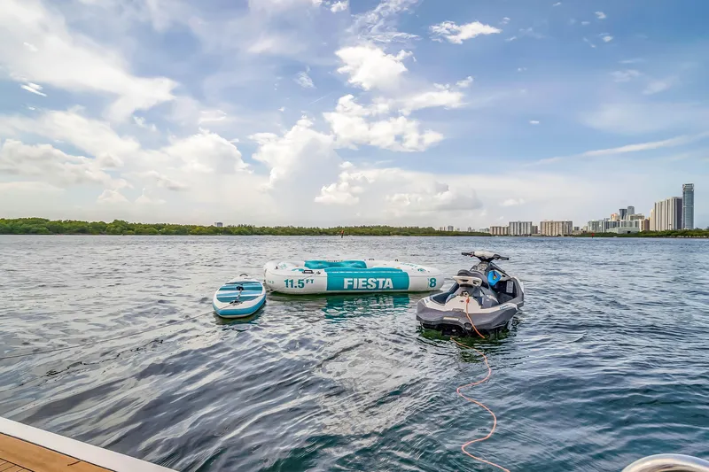 Yacht Photos Pics Jet ski and inflatable raft on water near city skyline, Azimut 2012.