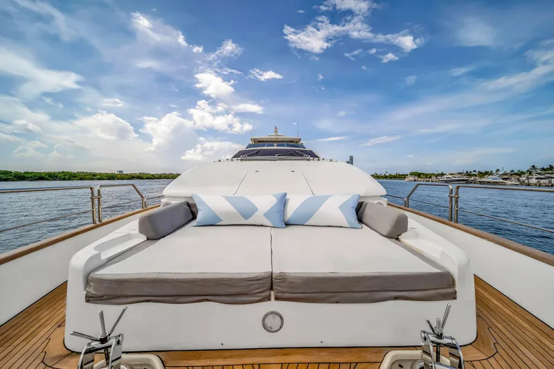  Yacht Photos Pics Luxurious 2012 Azimut yacht deck with sunbed and cushions, set against a serene ocean backdrop.
