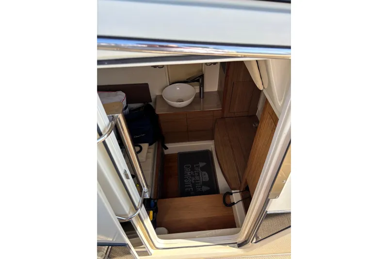  Yacht Photos Pics 2018 Chris-Craft 350 Catalina cabin interior with wooden flooring and compact sink.