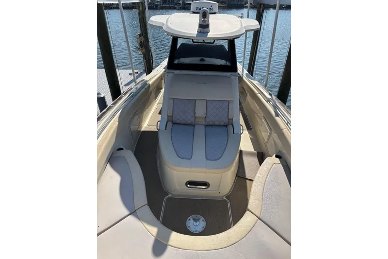  Yacht Photos Pics 2018 Chris-Craft 350 Catalina boat interior with cushioned seating and helm, docked by the water.