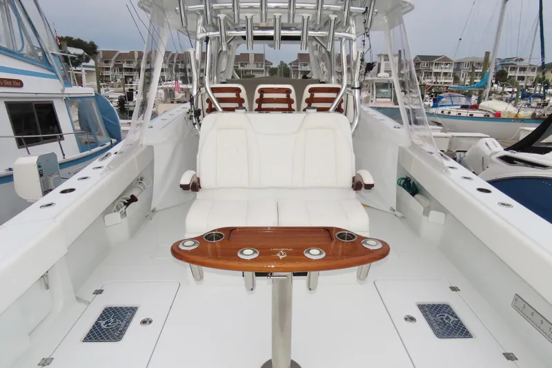  Yacht Photos Pics Luxury interior of 2024 Freeman 38 boat with white seating and wooden table.
