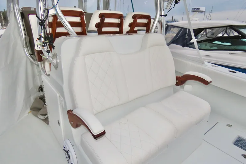  Yacht Photos Pics Luxurious seating on 2024 Freeman 38 boat with white upholstery and wooden accents.
