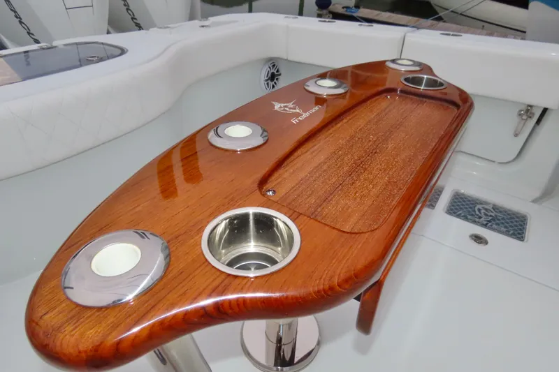  Yacht Photos Pics Luxurious 2024 Freeman 38 boat with polished wooden table and cup holders.
