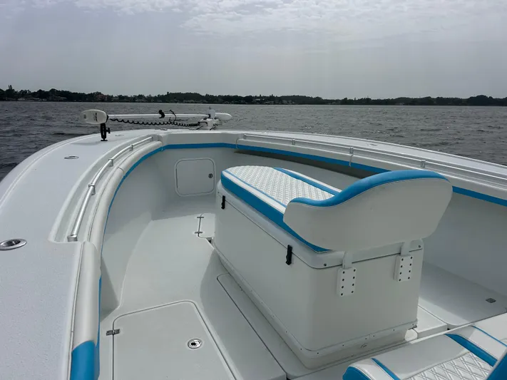 Blue Eyed Yacht Photos Pics 2016 Yellowfin 39 boat with white and blue seating, on calm waters.