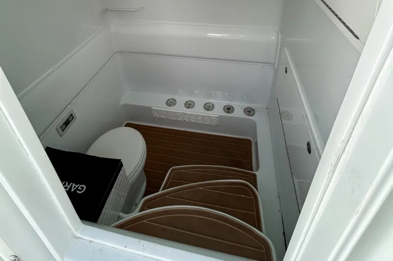 Blue Eyed Yacht Photos Pics 2016 Yellowfin 39 boat interior with toilet and wooden flooring.