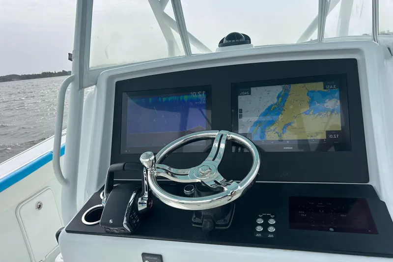 Blue Eyed Yacht Photos Pics 2016 Yellowfin 39 boat dashboard with navigation screens and steering wheel.